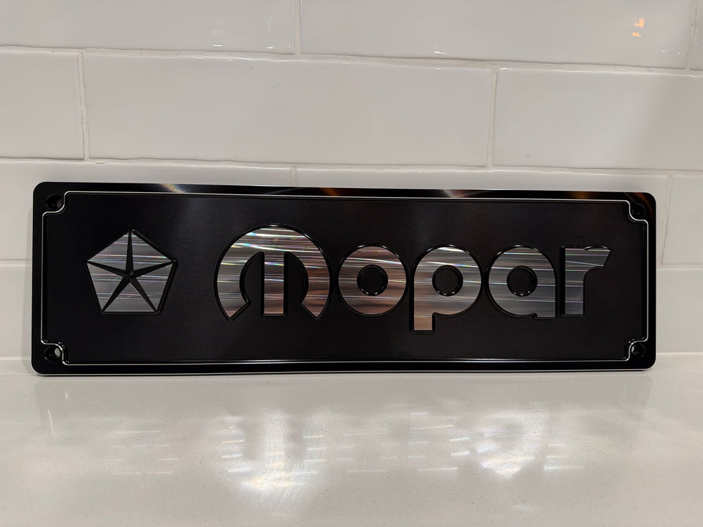 Mopar CNC machined display plate — black anodised with machined highlights