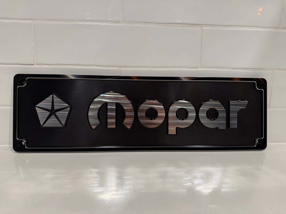 Mopar CNC machined display plate — black anodised with machined highlights